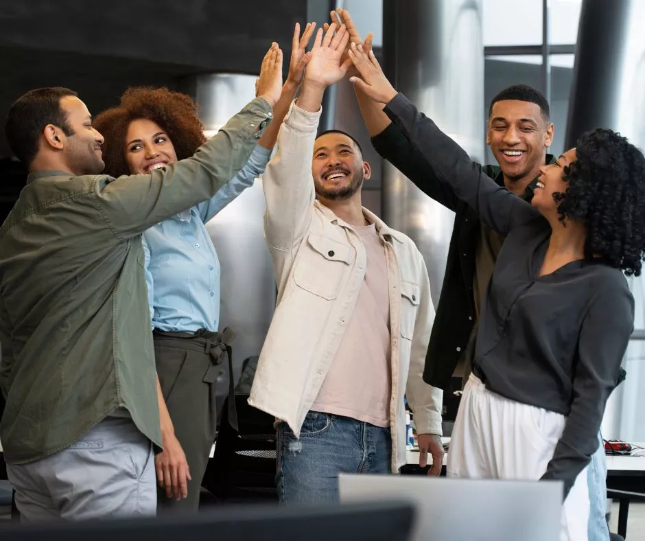 Grupo de colaboradores celebrando resultados del trabajo en equipo 