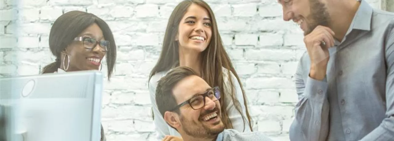 Colaboradores reunidos en un entorno laboral colaborativo, reflejando cultura organizacional y la importancia de tener un plan de retención de personal.