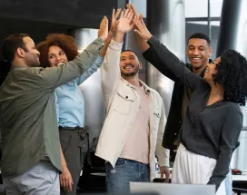 Grupo de colaboradores celebrando resultados del trabajo en equipo
